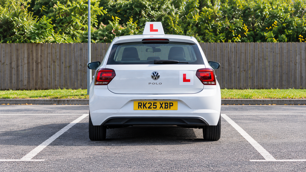 Learner driver carrying out forward bay parking manoeuvre on driving test